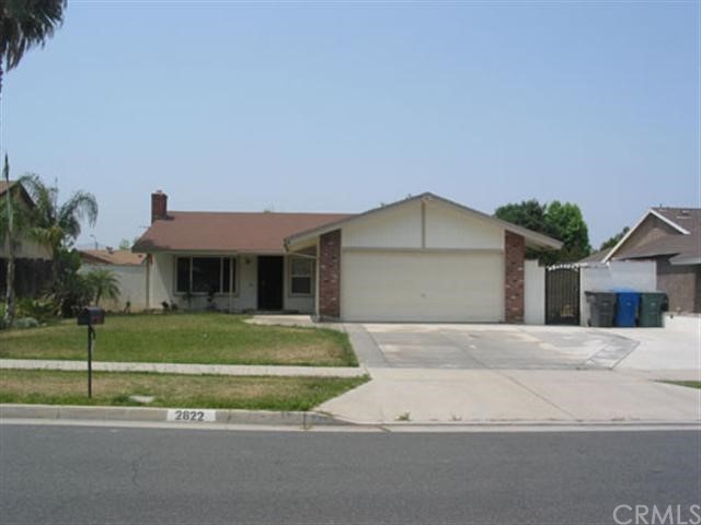 2822 Loyola Street Riverside, CA 92503 - Photo 1 of 1 a front view of a house with a garden and parking