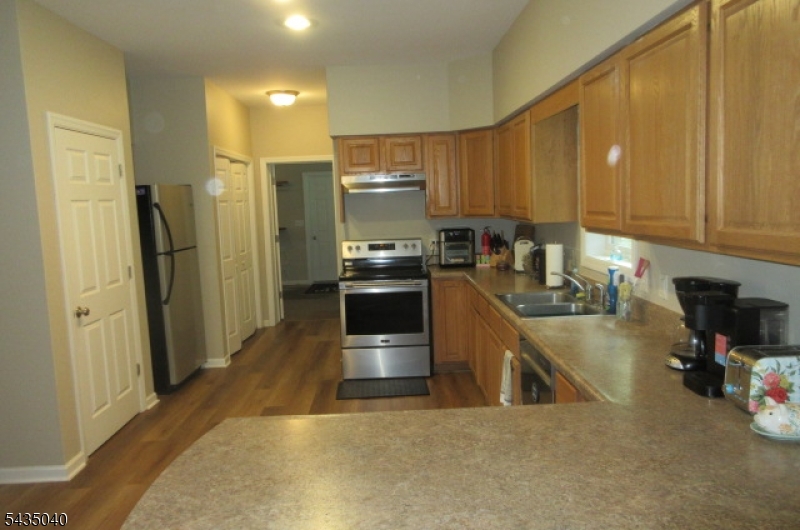 28 Beaver Run Road Lafayette, NJ 07848 - Photo 30 of 36 a kitchen with stainless steel appliances a stove a sink a refrigerator white cabinets and wooden floor