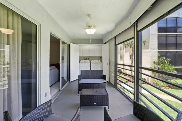 a view of a hallway with a livingroom and furniture