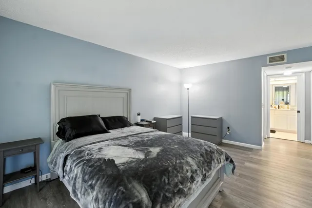 a bedroom with a bed and a view of kitchen