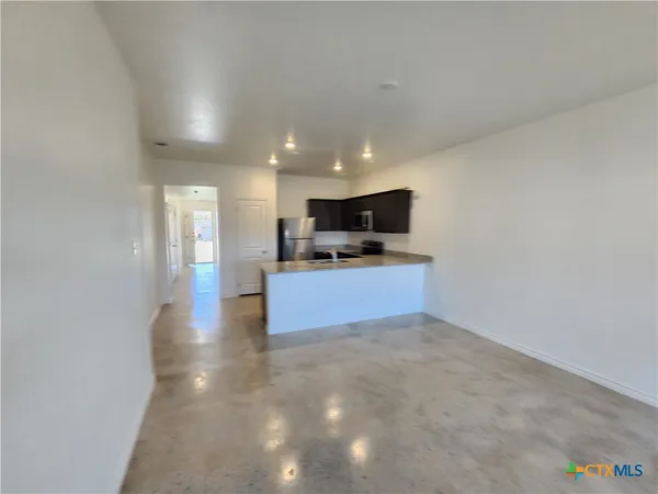a view of a kitchen with a sink and a microwave