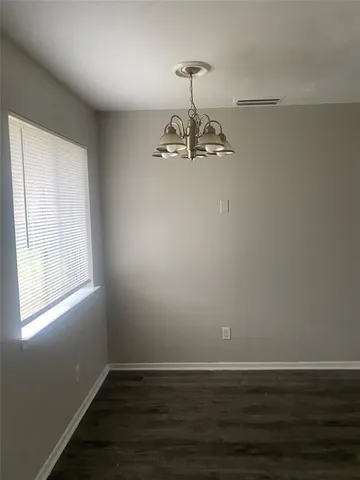 a room with a window and wooden floor