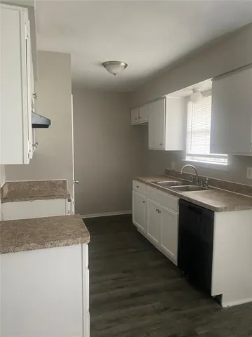 a kitchen with granite countertop a sink and a stove top oven