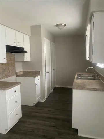 a kitchen with a stove microwave and cabinets