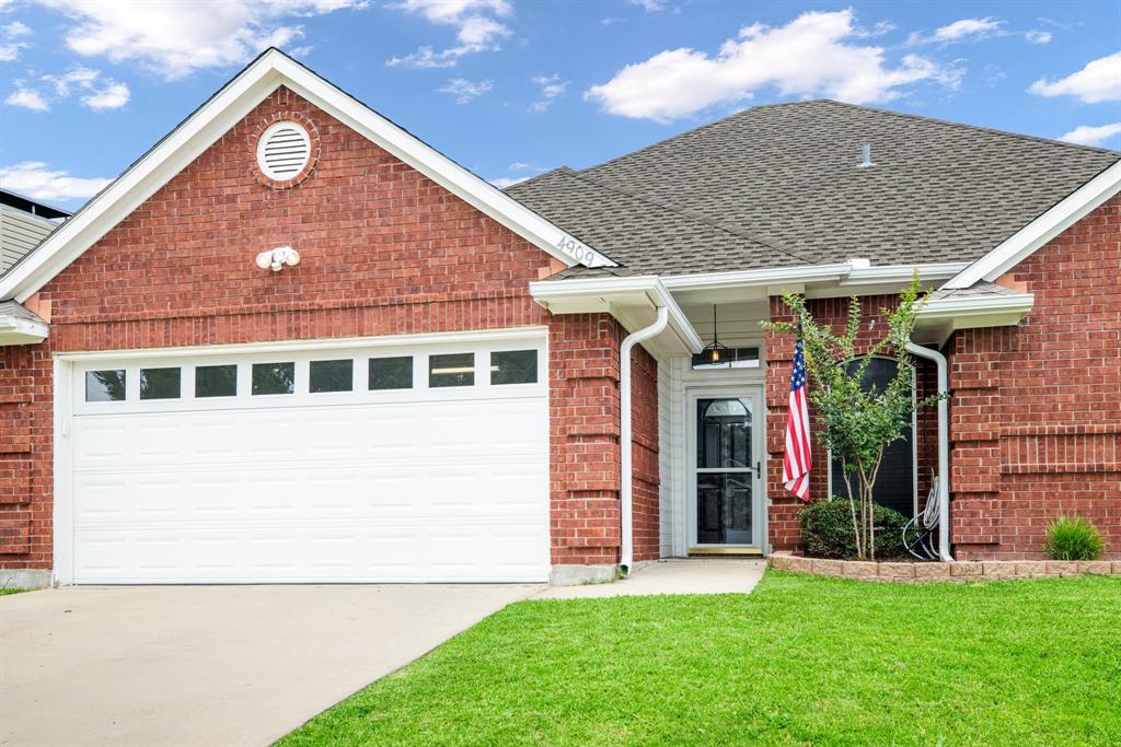 a front view of a house with a garden and plants