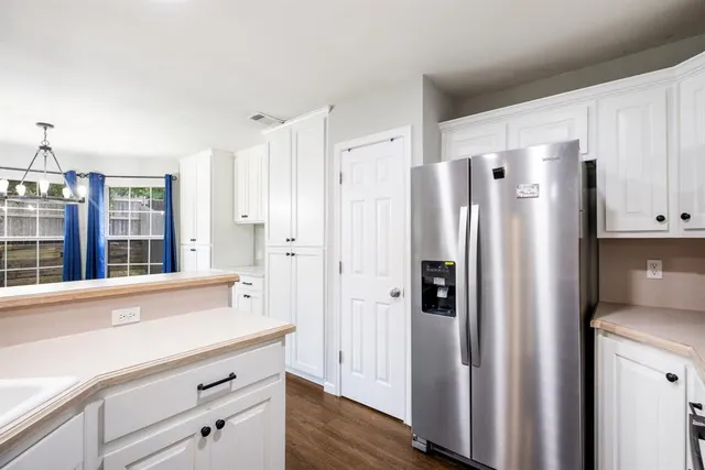 a spacious bathroom with a shower a sink and a large mirror