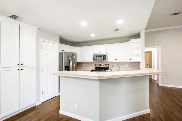 a kitchen with stainless steel appliances a sink and refrigerator