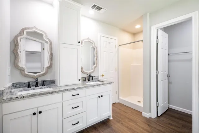 a bathroom with a double vanity sink mirror and