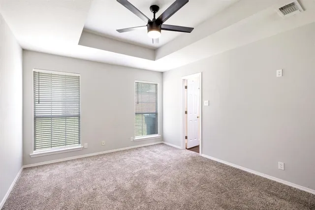 a view of a livingroom with a ceiling fan and window