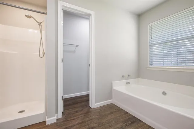 a white bath tub sitting next to a shower