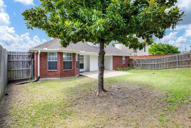 a view of a house with a backyard porch and sitting area