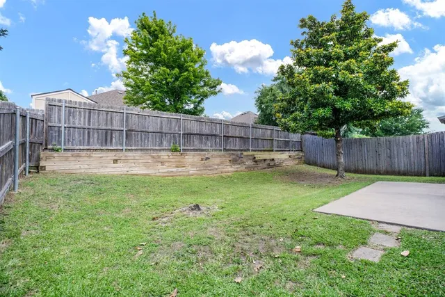 a view of a backyard with a fence