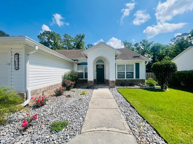 front view of a house with a yard