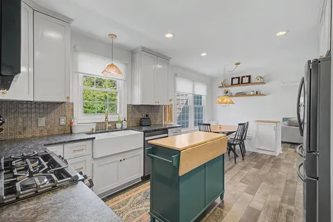 a kitchen with a sink stove and refrigerator