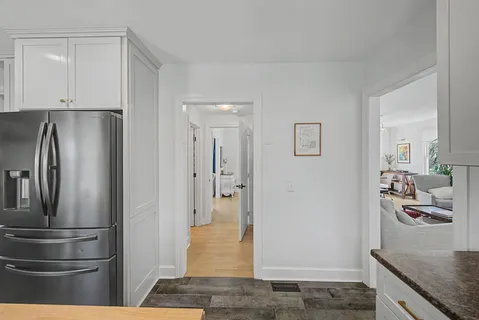 a kitchen with stainless steel appliances granite countertop a refrigerator and a sink