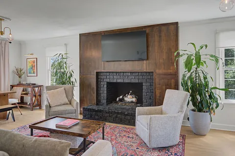a living room with furniture and a fireplace