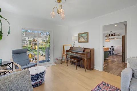 a living room with furniture and a piano