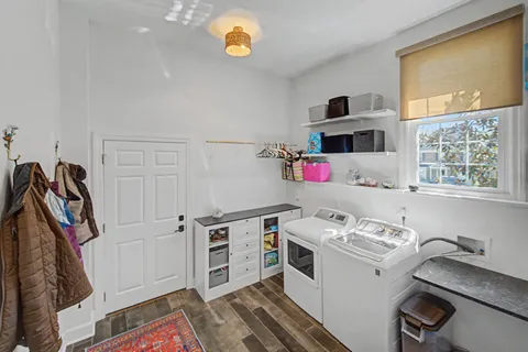 a view of a kitchen with fridge and wooden floor