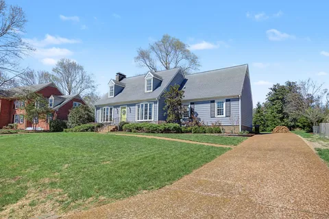 a front view of a house with a garden and plants