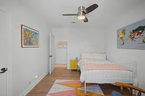 a bedroom with a bed a couches and a potted plant