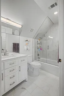 a bathroom with a shower toilet and sink