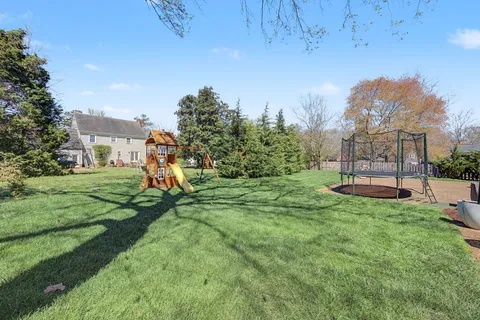 a view of a house with backyard porch and sitting area