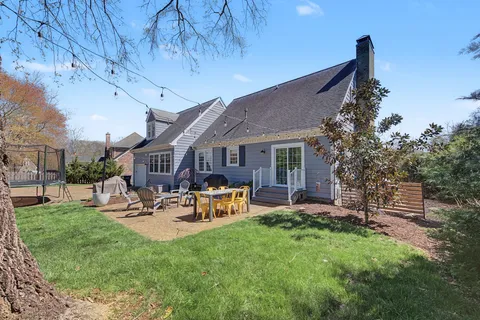 a view of a house with a yard and porch