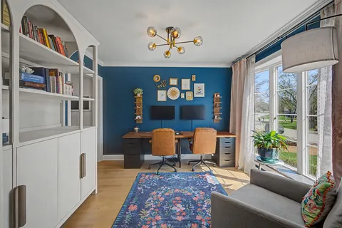a living room with furniture fireplace and a window