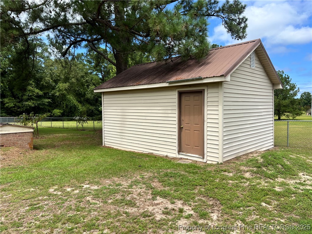 10981 Academy Road Laurinburg, NC 28352 - Photo 6 of 8 a backyard of a house with lots of green space