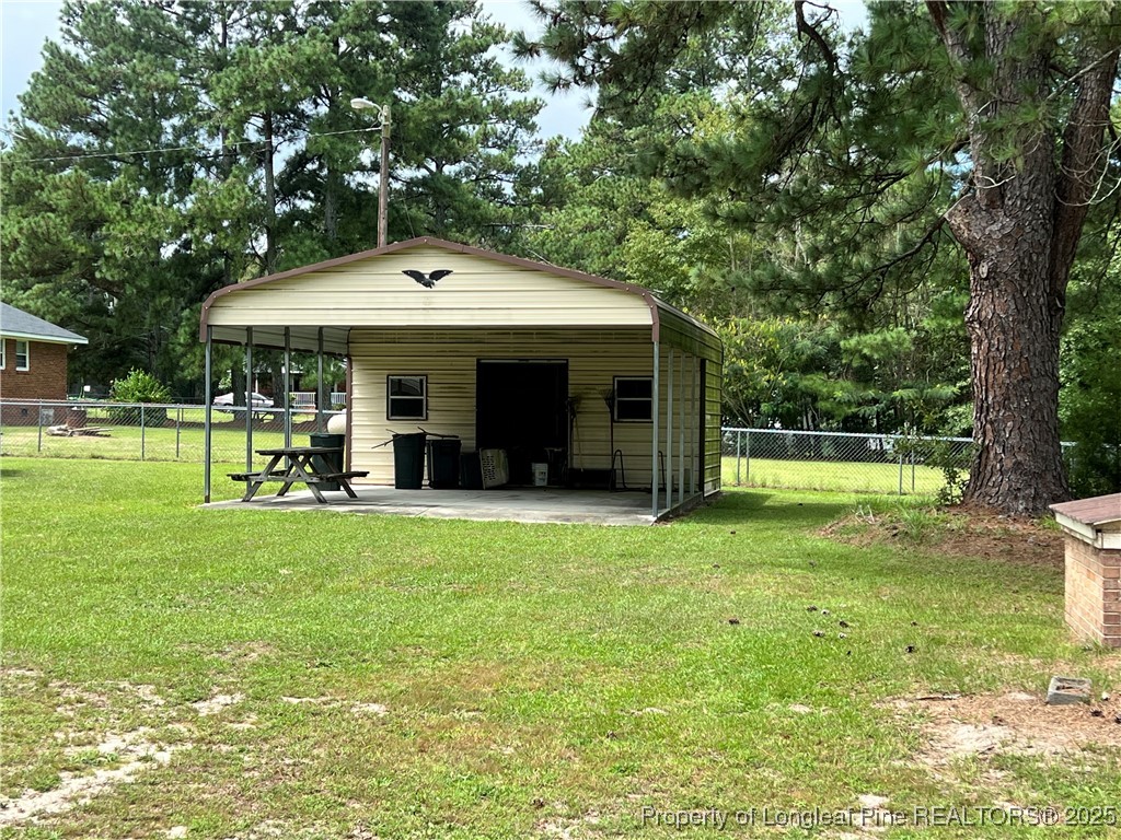 10981 Academy Road Laurinburg, NC 28352 - Photo 7 of 8 a view of a house with backyard and porch