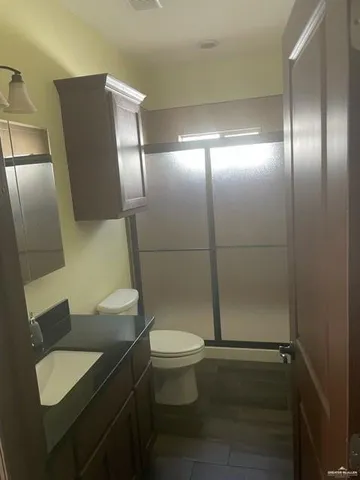 a bathroom with a toilet and a shower