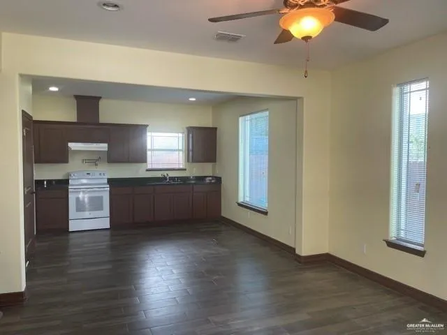 a kitchen with stainless steel appliances kitchen island wooden cabinets and granite counter tops