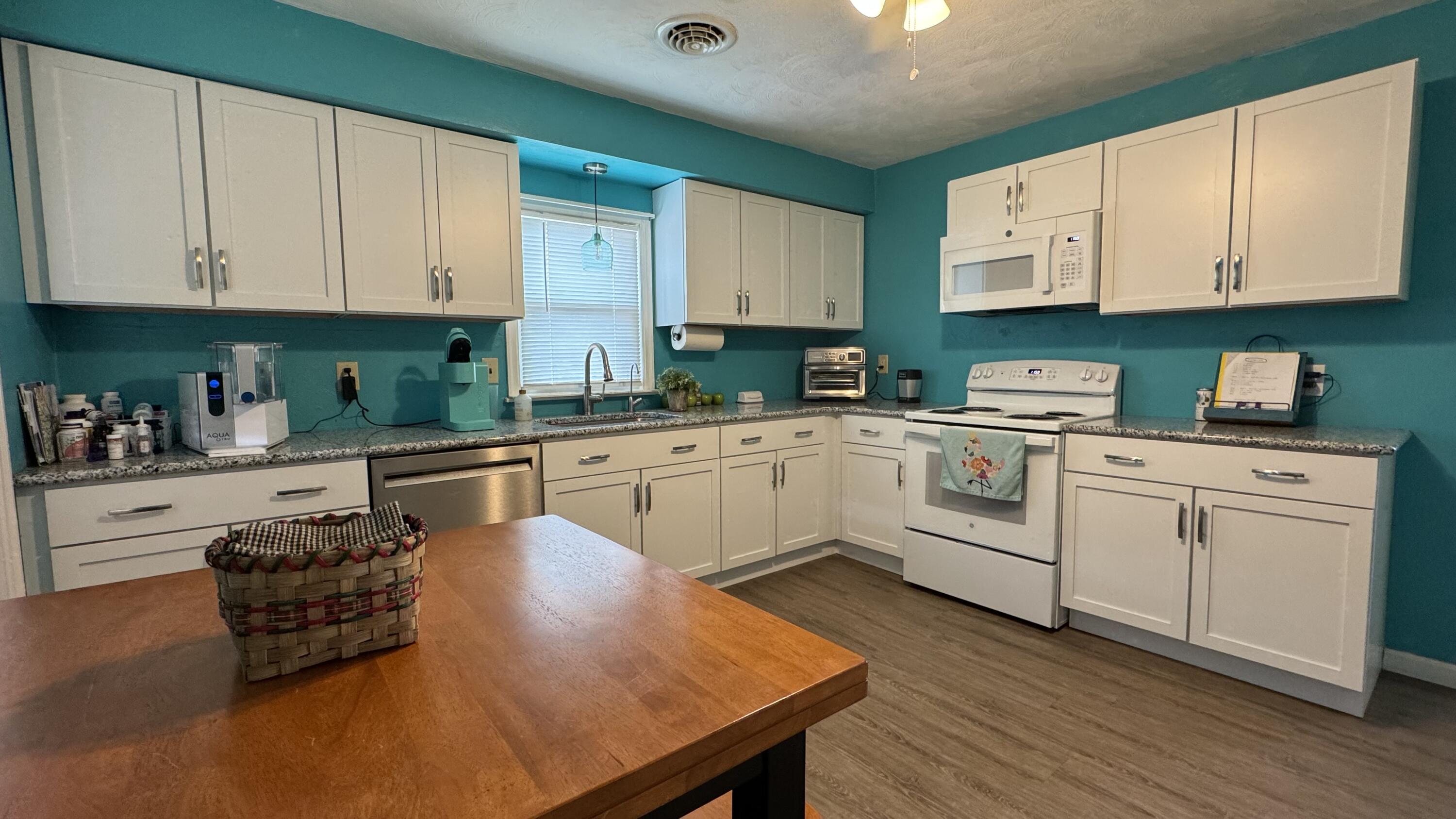 1902 Burma Road Salem, VA 24153 - Photo 4 of 17 a kitchen with white cabinets and white appliances