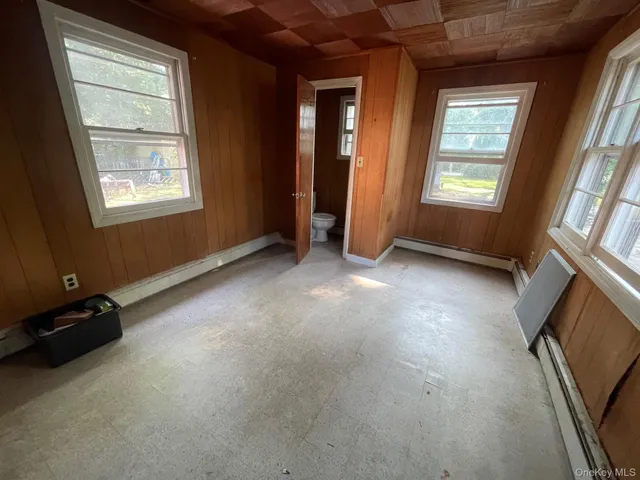 an empty room with windows and closet