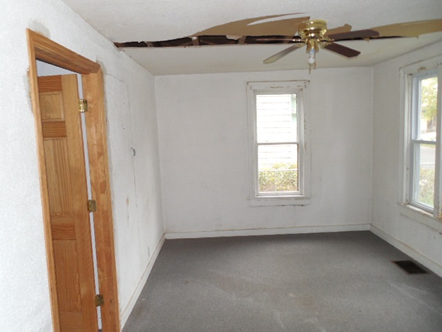 206 Adams Street Ridott, IL 61067 - Photo 2 of 8 a view of an empty room with a window