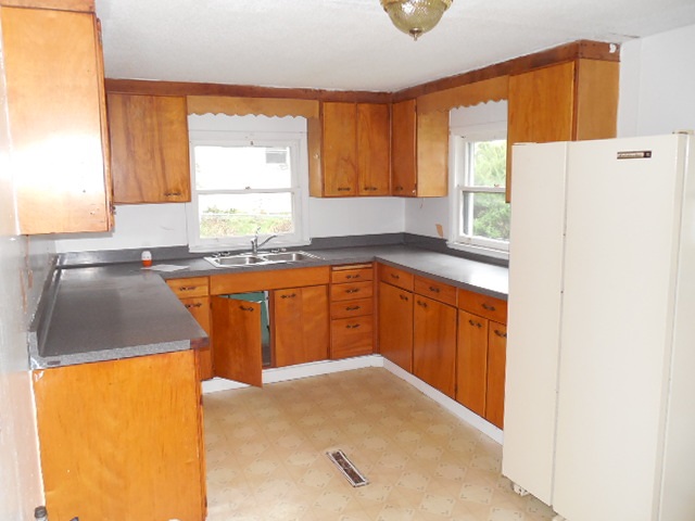 206 Adams Street Ridott, IL 61067 - Photo 4 of 8 a kitchen with stainless steel appliances granite countertop a sink stove and refrigerator