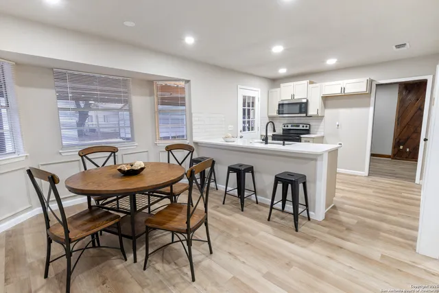 a view of a dining room with furniture and wooden floor