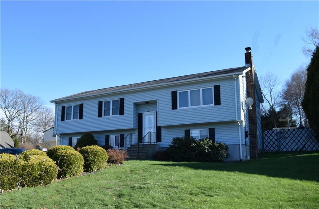 61 Chipper Road Waterbury, CT 06704 - Photo 1 of 1 a view of a house with a yard plants and large tree