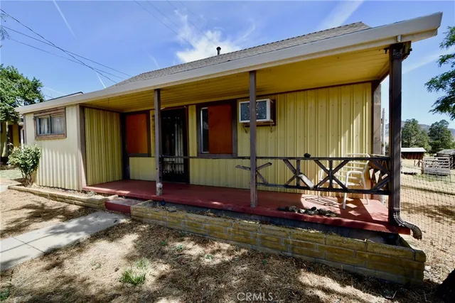 a view of a house with wooden fence