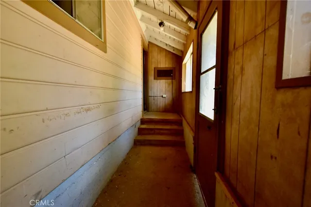 a view of a livingroom with furniture and staircase