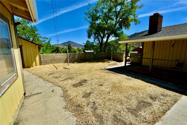 a view of house with yard and entertaining space