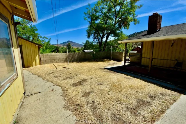 a view of house with yard and entertaining space