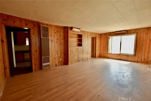 an empty room with windows and closet