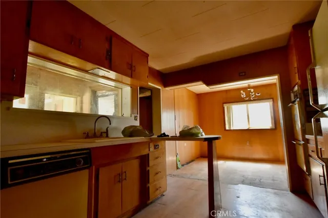a kitchen with a sink and a refrigerator