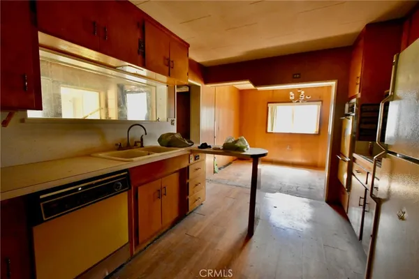 a kitchen with stainless steel appliances granite countertop a sink a stove and a refrigerator