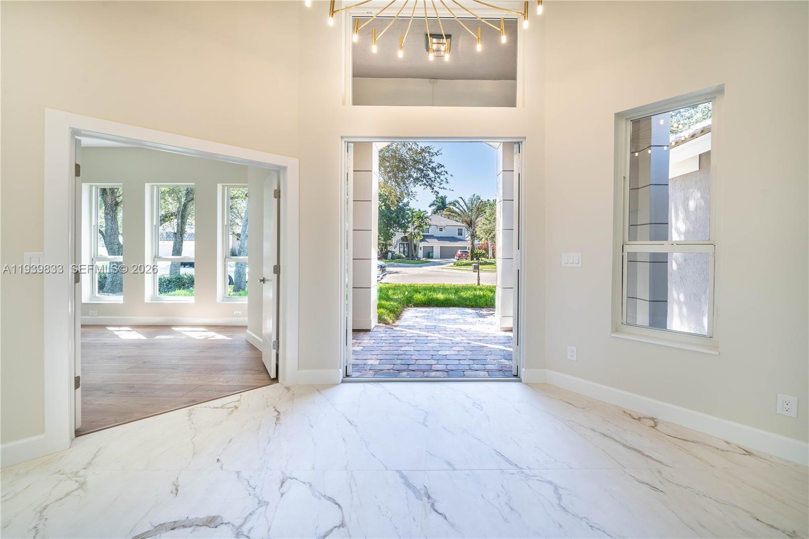 8041 Bermuda Point Lane Davie, FL 33328 - Photo 11 of 60 an empty room with floor to ceiling windows and a livingroom