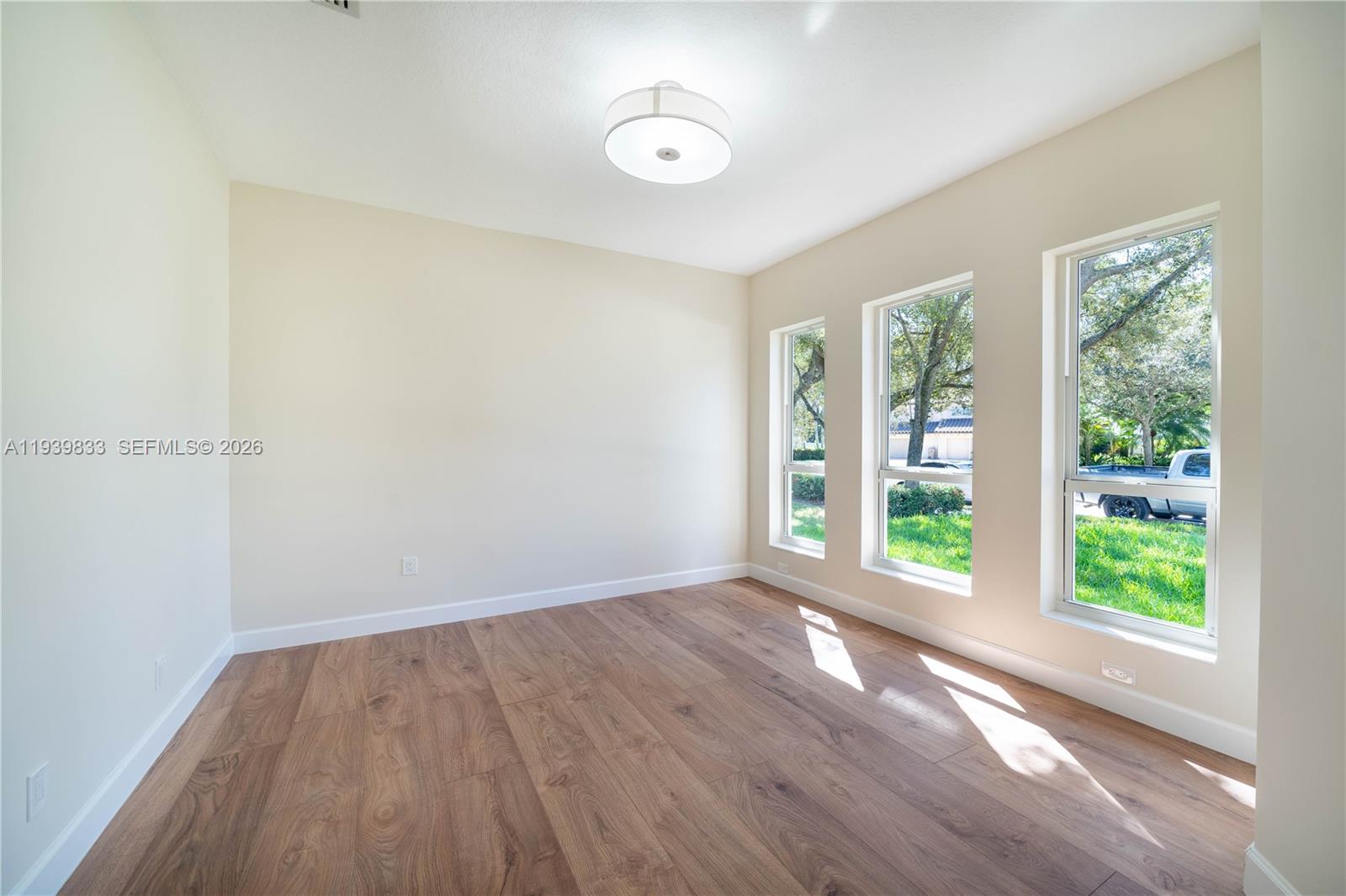 8041 Bermuda Point Lane Davie, FL 33328 - Photo 17 of 60 an empty room with wooden floor and windows