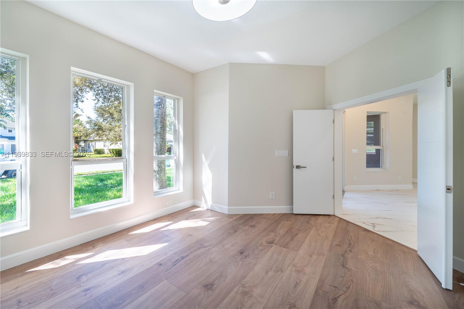 8041 Bermuda Point Lane Davie, FL 33328 - Photo 18 of 60 an empty room with wooden floor and windows