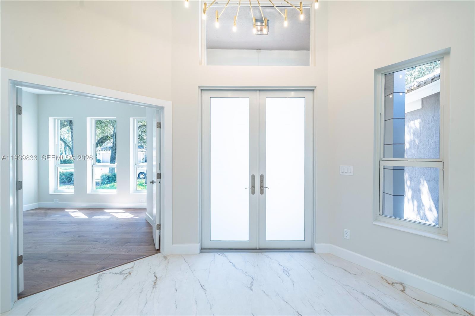 8041 Bermuda Point Lane Davie, FL 33328 - Photo 20 of 60 an empty room with windows and entrance