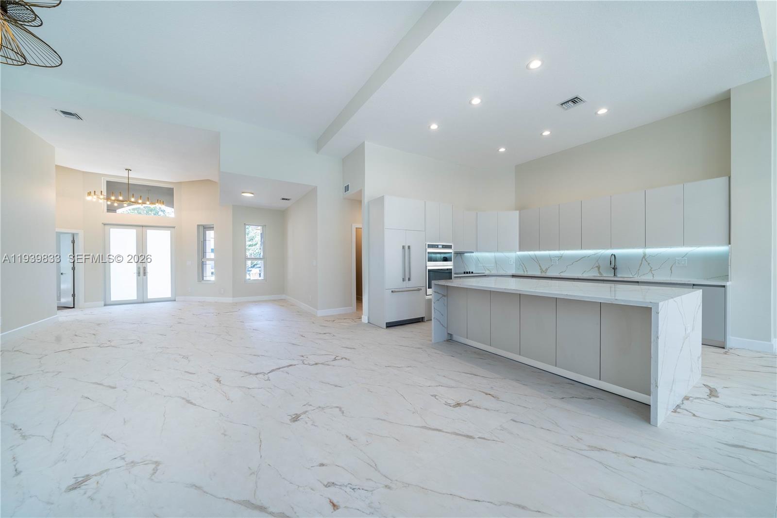 8041 Bermuda Point Lane Davie, FL 33328 - Photo 21 of 60 a large white kitchen with a sink and dishwasher